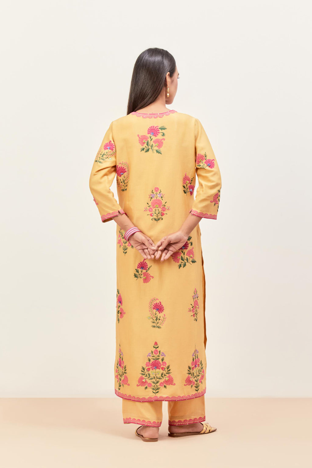 Yellow silk chanderi straight kurta set with all-randomly placed appliqued assorted bootas, highlighted with aari threadwork & sequins.