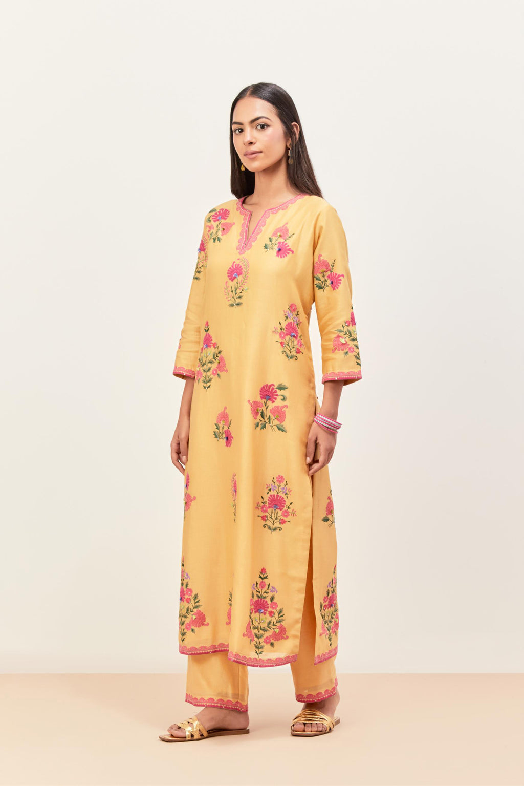 Yellow silk chanderi straight kurta set with all-randomly placed appliqued assorted bootas, highlighted with aari threadwork & sequins.