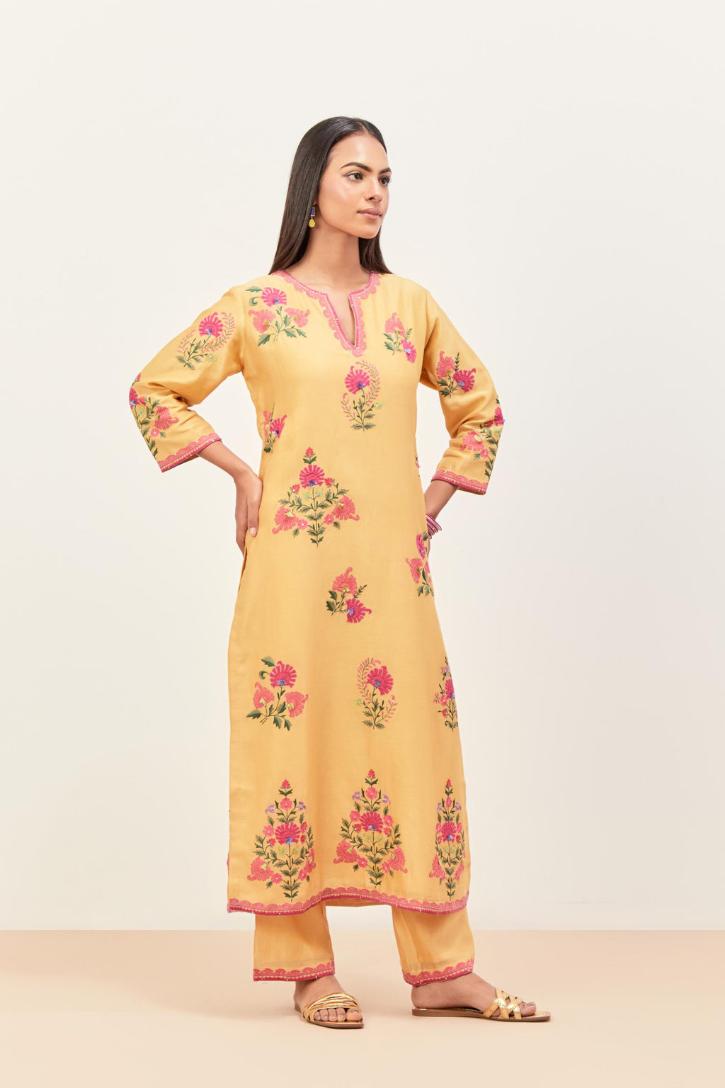 Yellow silk chanderi straight kurta set with all-randomly placed appliqued assorted bootas, highlighted with aari threadwork & sequins.
