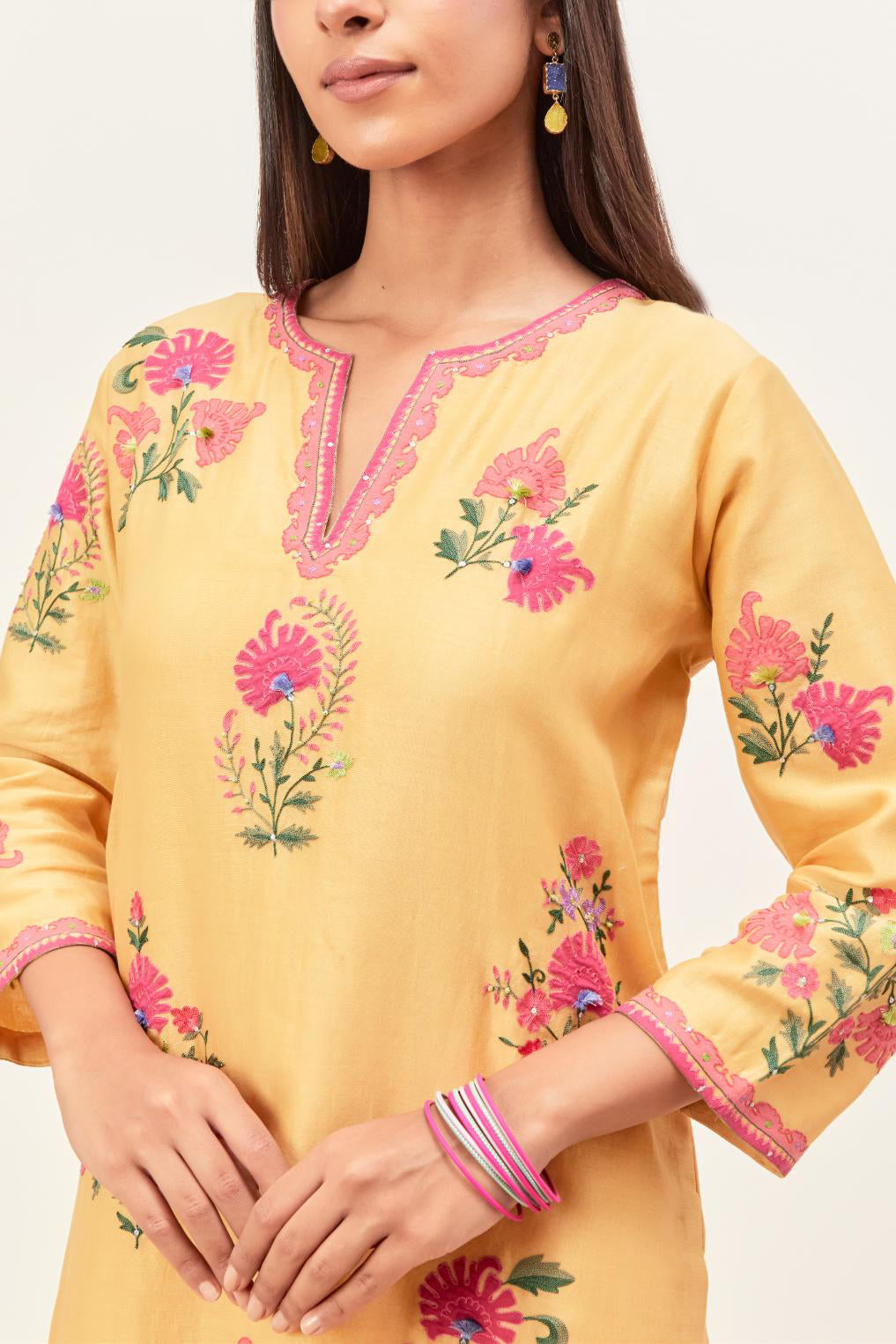 Yellow silk chanderi straight kurta set with all-randomly placed appliqued assorted bootas, highlighted with aari threadwork & sequins.