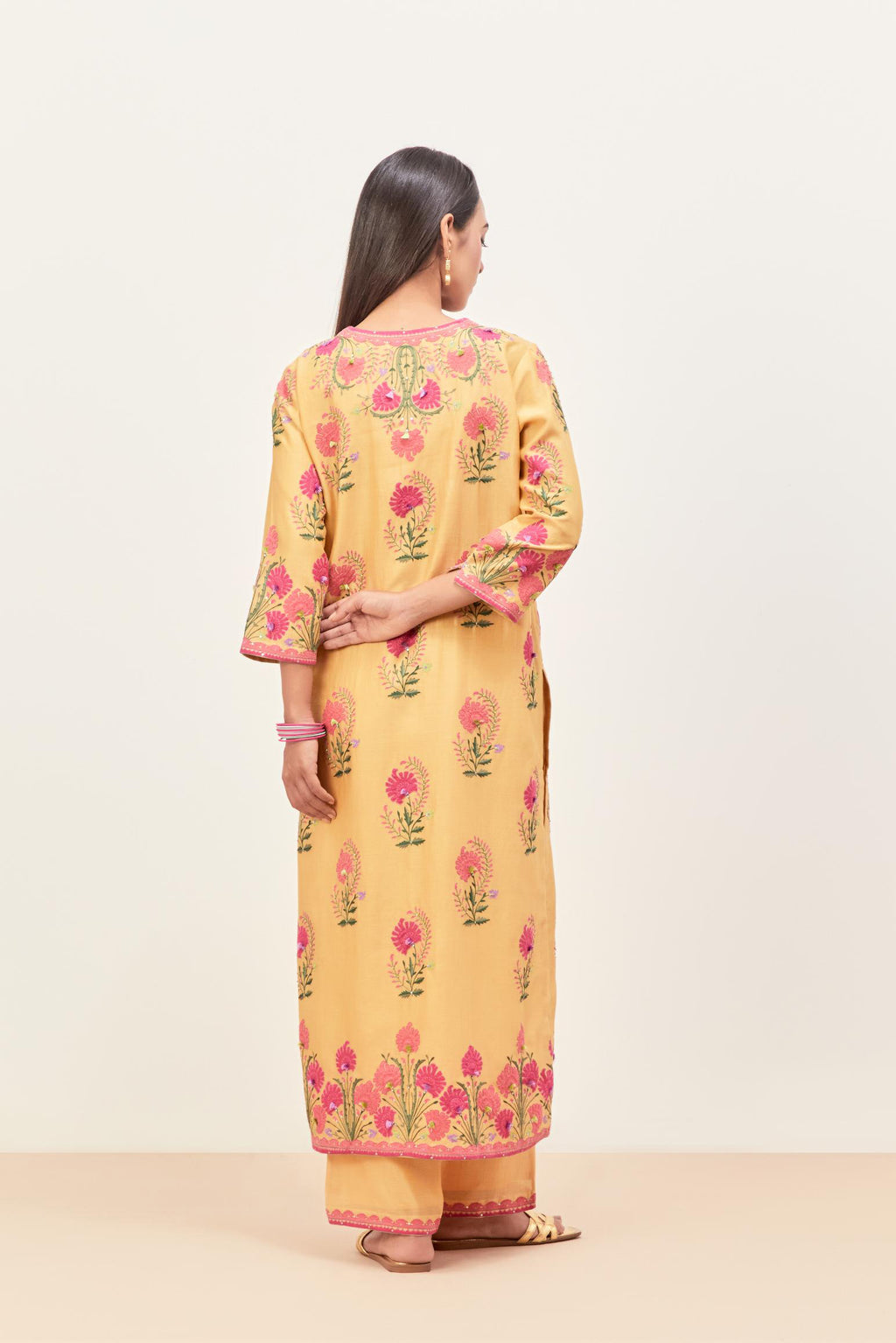 Yellow silk chanderi straight kurta set, decorated with appliqued jaal neckline and hem. The field has symmetrically placed bootas.