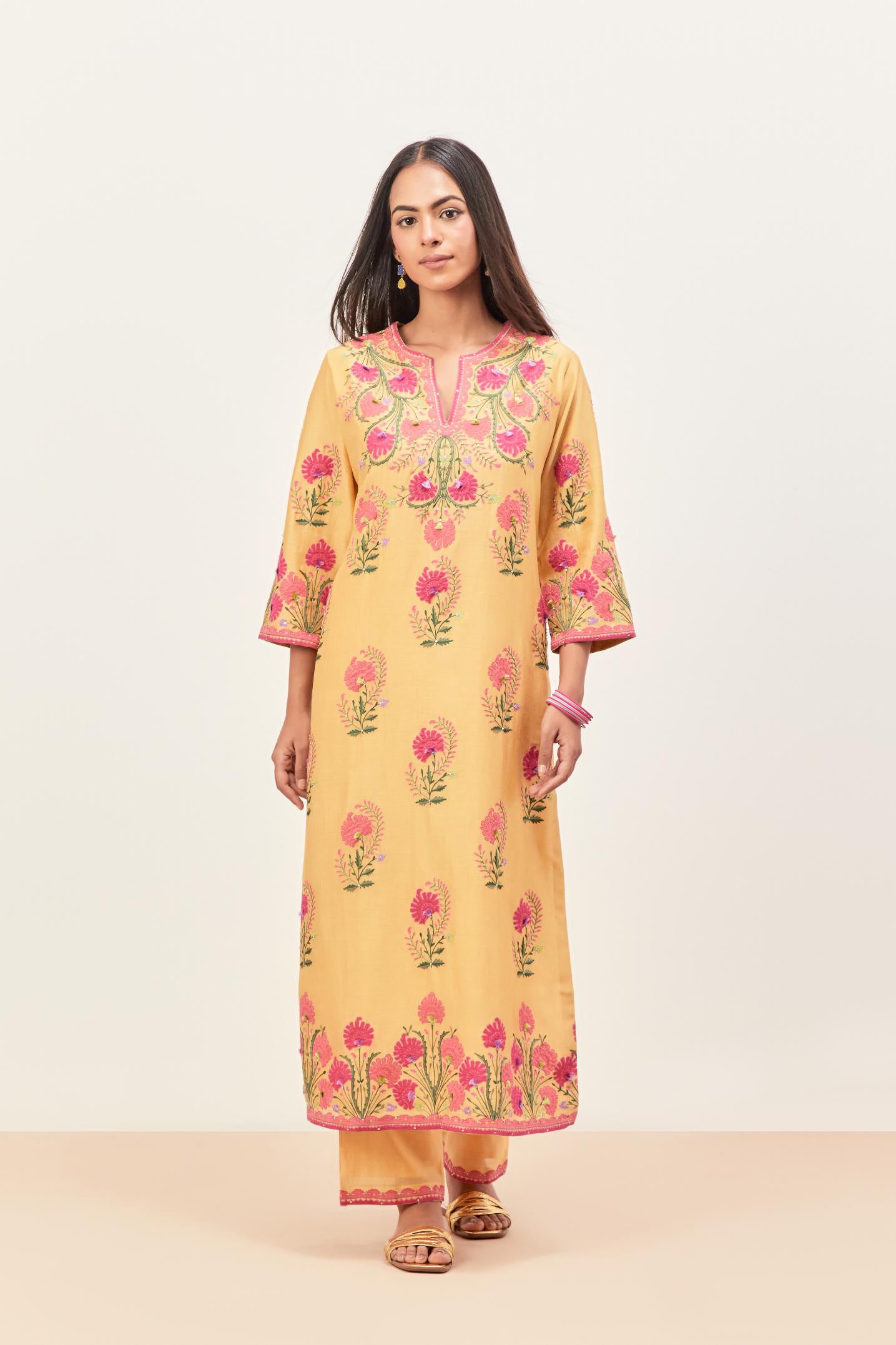 Yellow silk chanderi straight kurta set, decorated with appliqued jaal neckline and hem. The field has symmetrically placed bootas.