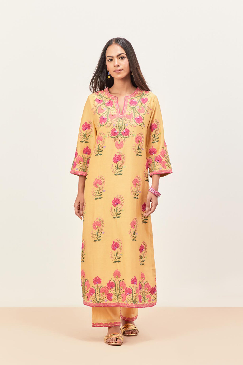 Yellow silk chanderi straight kurta set, decorated with appliqued jaal neckline and hem. The field has symmetrically placed bootas.