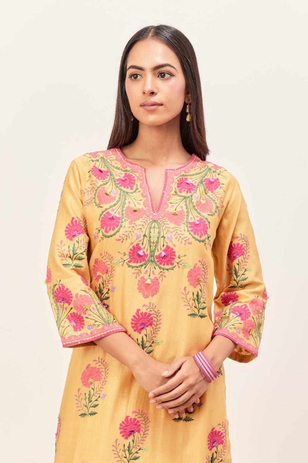 Yellow silk chanderi straight kurta set, decorated with appliqued jaal neckline and hem. The field has symmetrically placed bootas.
