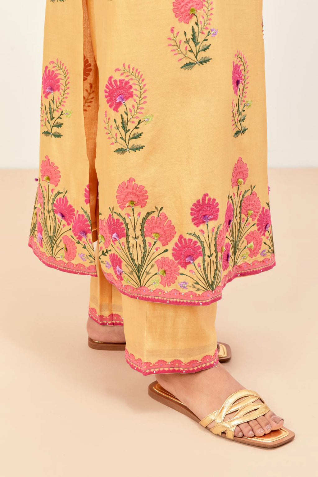 Yellow silk chanderi straight kurta set, decorated with appliqued jaal neckline and hem. The field has symmetrically placed bootas.