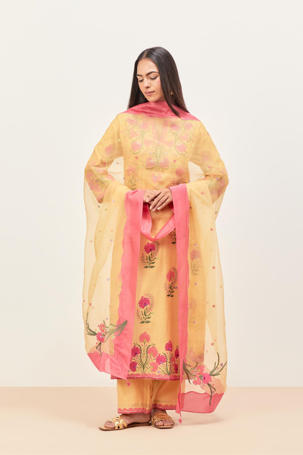 Yellow silk chanderi straight kurta set, decorated with appliqued jaal neckline and hem. The field has symmetrically placed bootas.