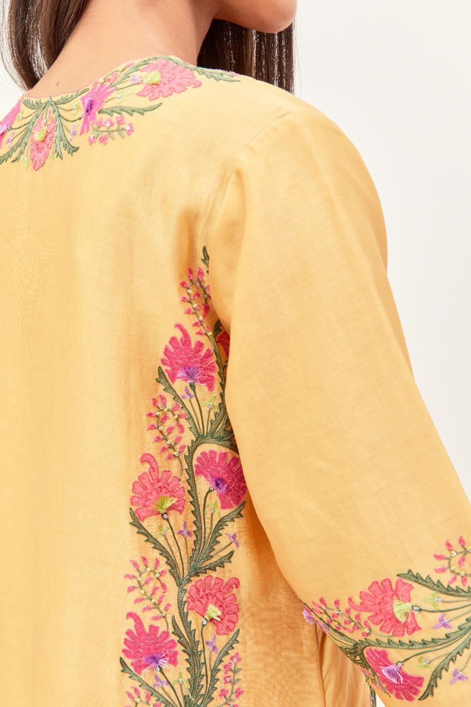 Yellow silk chanderi straight kurta set, decorated with appliqué borders along the side panels, neck and sleeves.