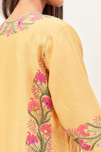 Yellow silk chanderi straight kurta set, decorated with appliqué borders along the side panels, neck and sleeves.