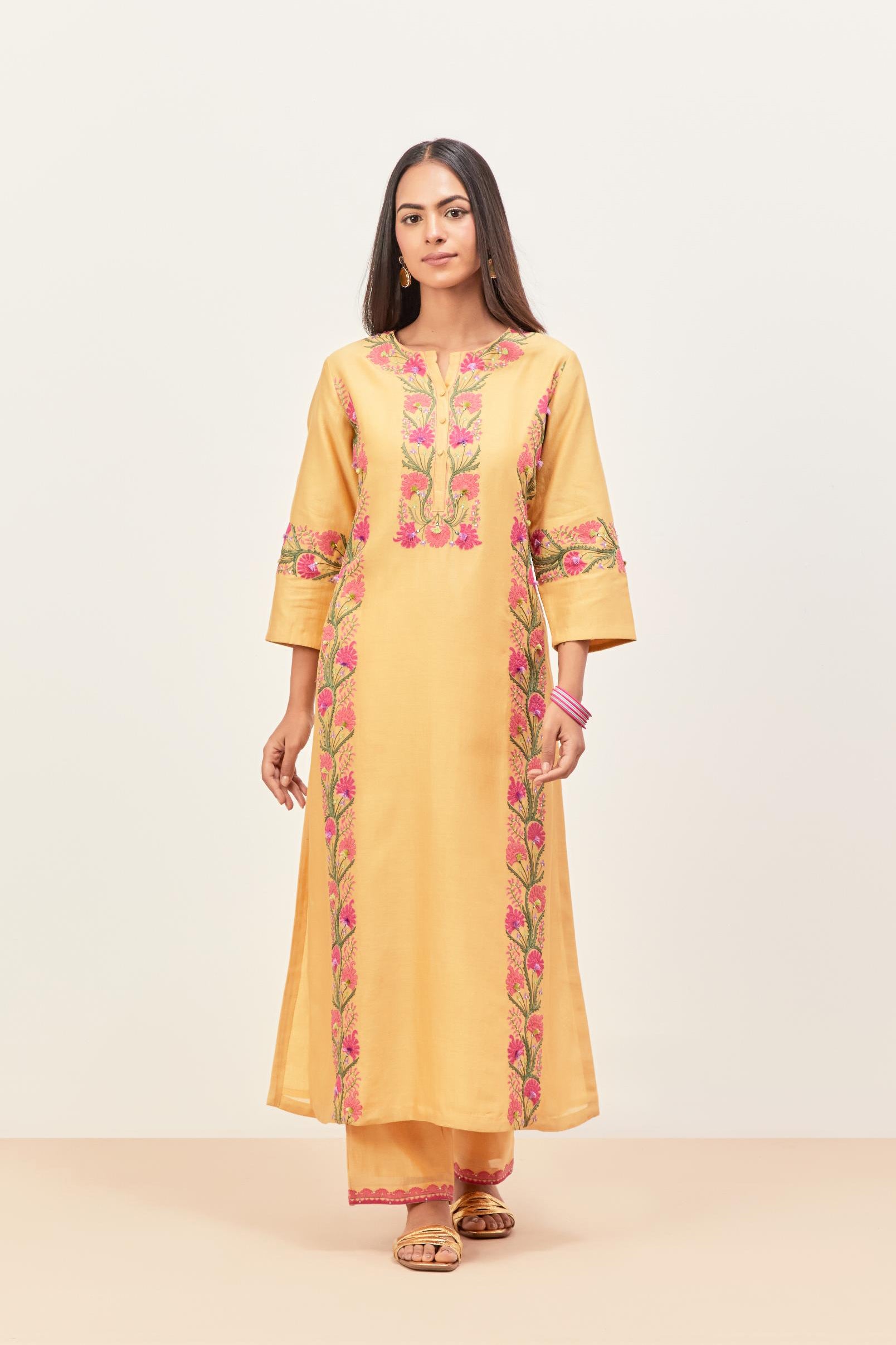 Yellow silk chanderi straight kurta set, decorated with appliqué borders along the side panels, neck and sleeves.