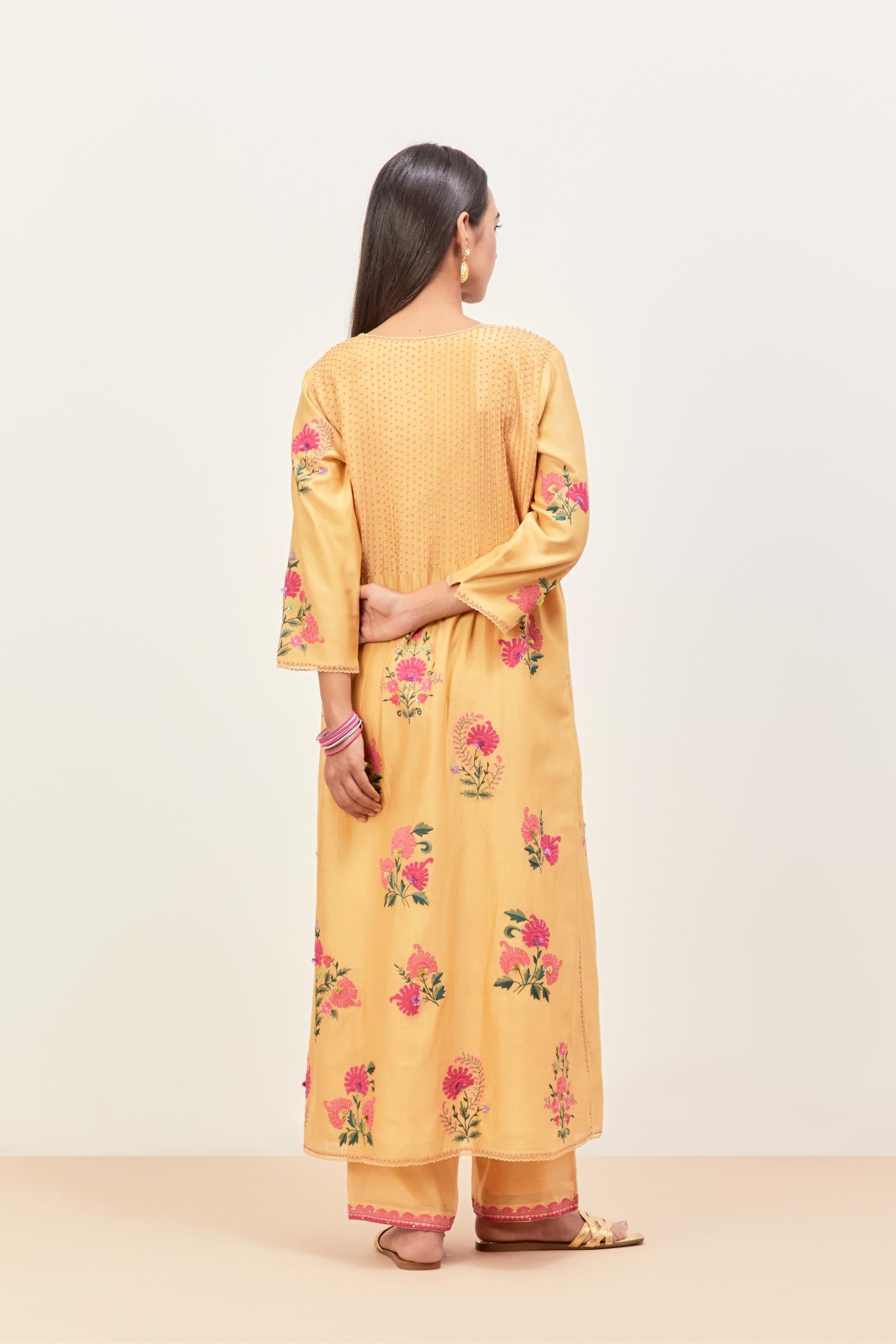 Yellow silk chanderi kurta set with pin tucks at yoke and all-over applique, highlighted with aari threadwork & sequins.