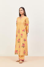 Yellow silk chanderi kurta set with pin tucks at yoke and all-over applique, highlighted with aari threadwork & sequins.