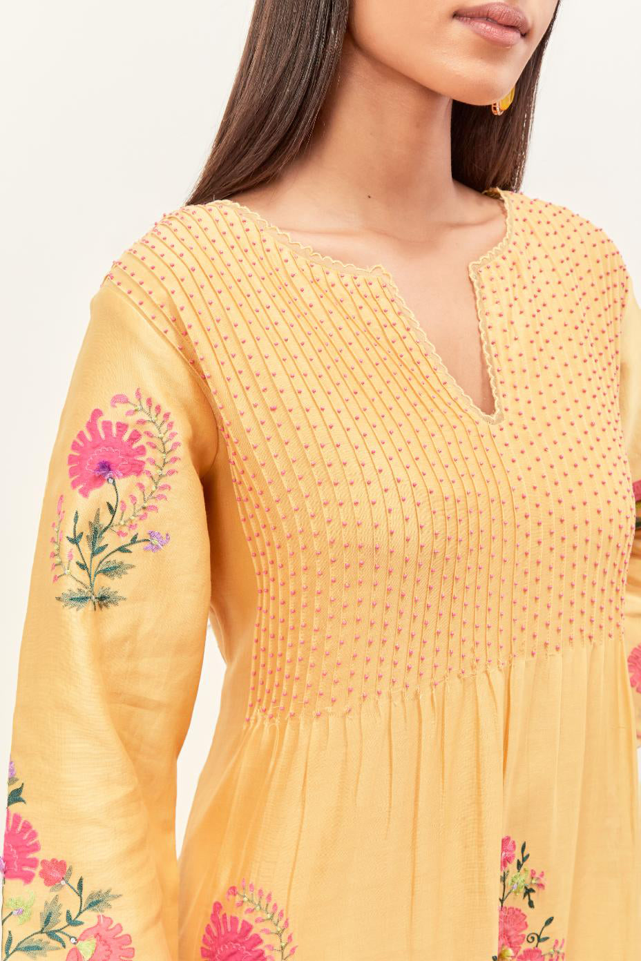 Yellow silk chanderi kurta set with pin tucks at yoke and all-over applique, highlighted with aari threadwork & sequins.