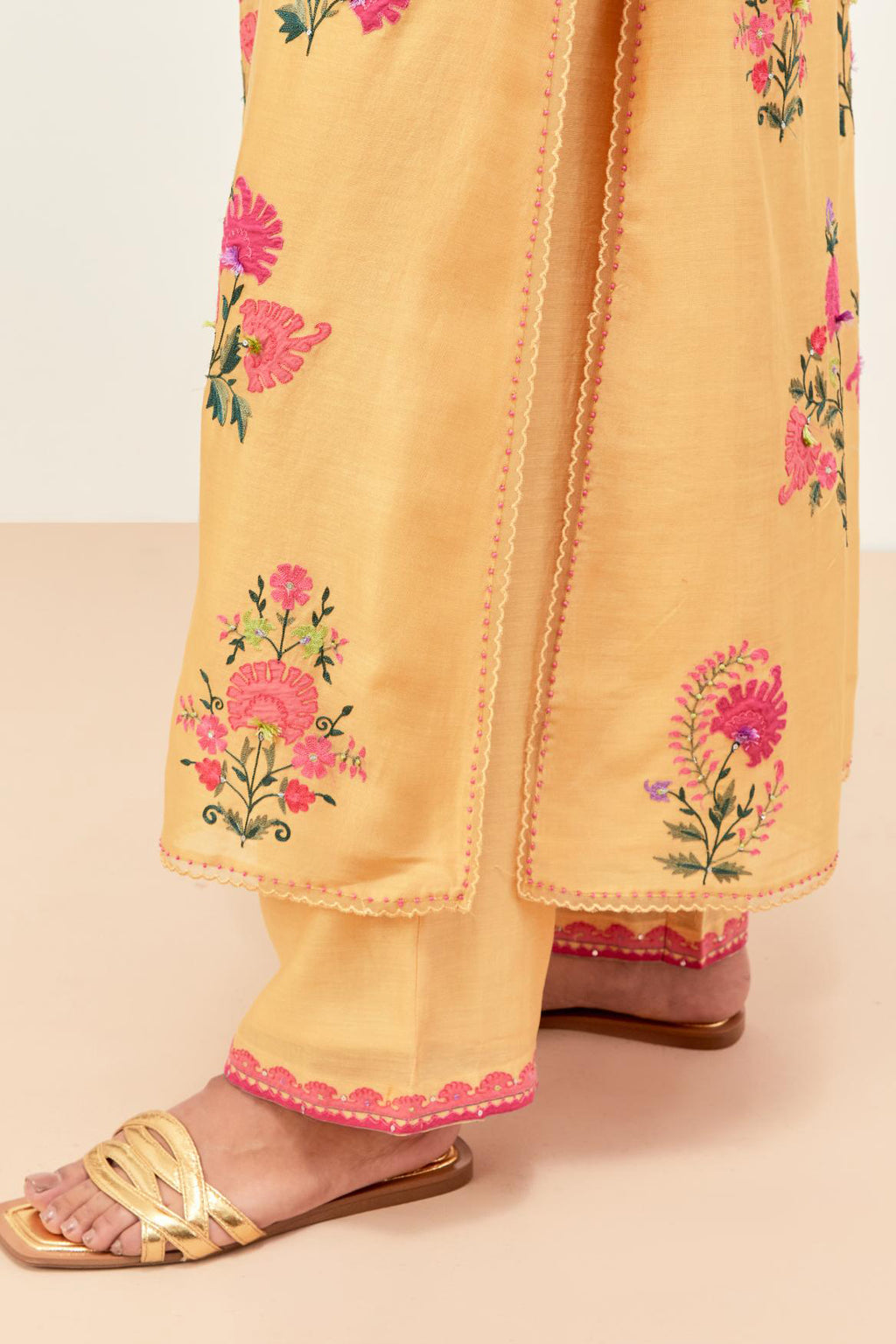 Yellow silk chanderi kurta set with pin tucks at yoke and all-over applique, highlighted with aari threadwork & sequins.