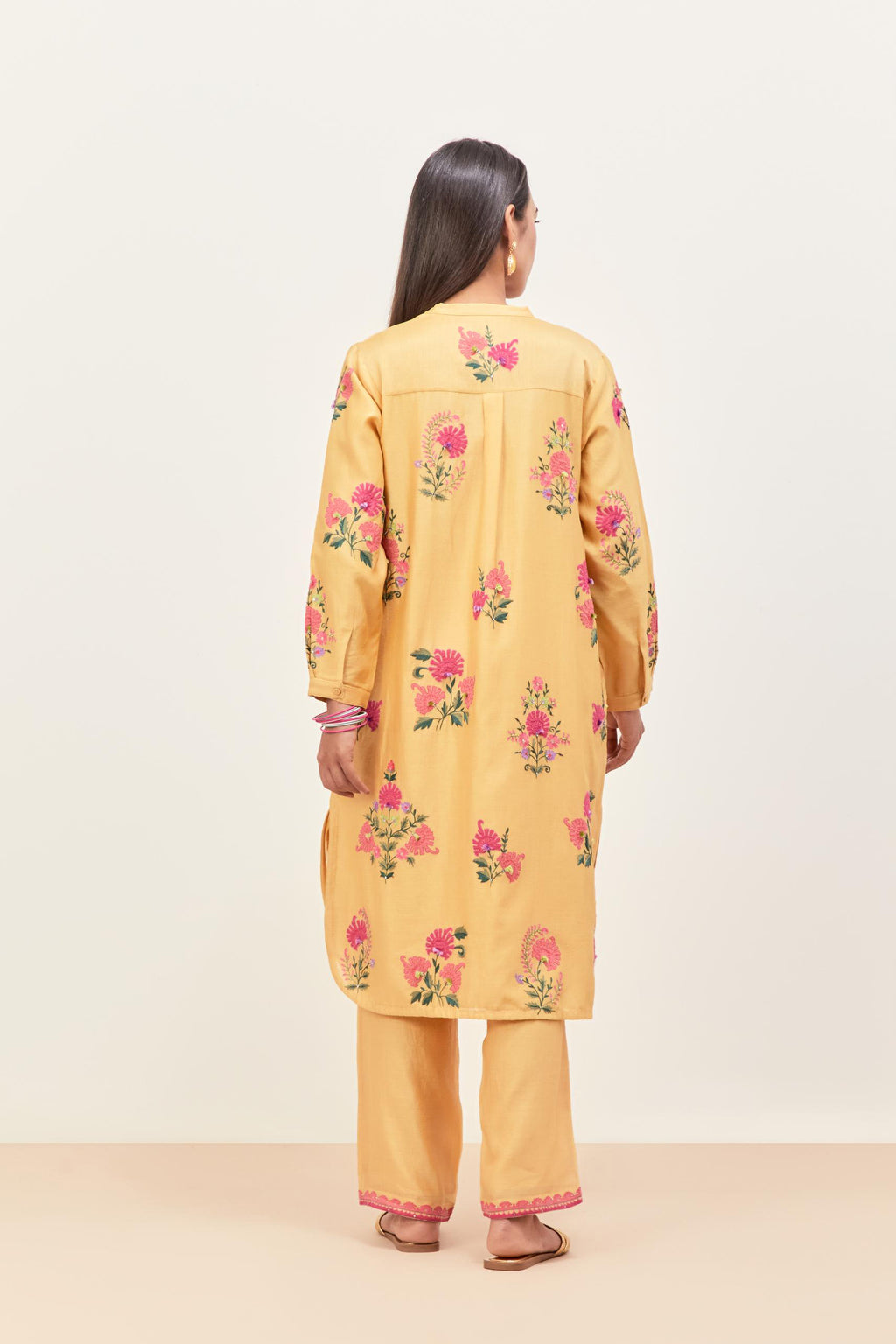 Yellow silk chanderi straight short easy fit kurta set with all-over assorted flower applique, highlighted with aari threadwork & sequins.