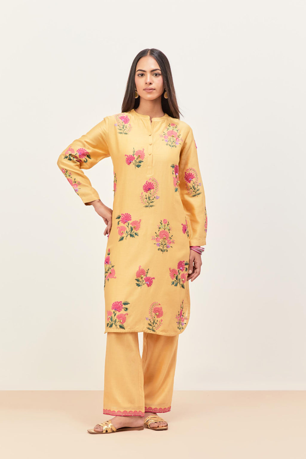 Yellow silk chanderi straight short easy fit kurta set with all-over assorted flower applique, highlighted with aari threadwork & sequins.