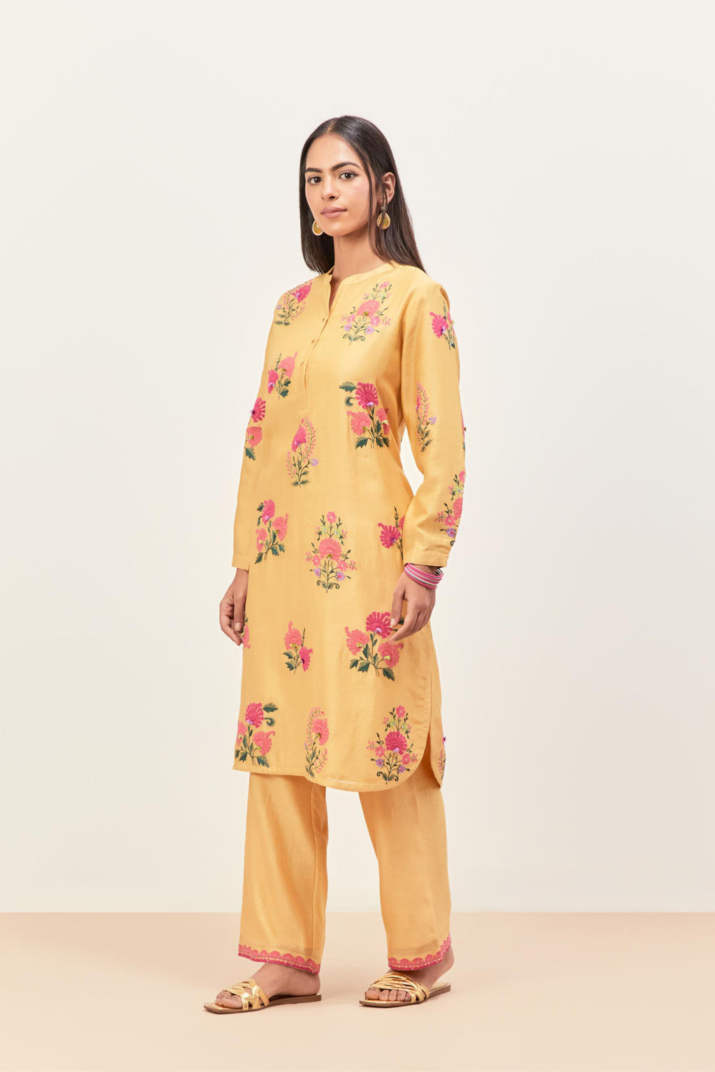 Yellow silk chanderi straight short easy fit kurta set with all-over assorted flower applique, highlighted with aari threadwork & sequins.