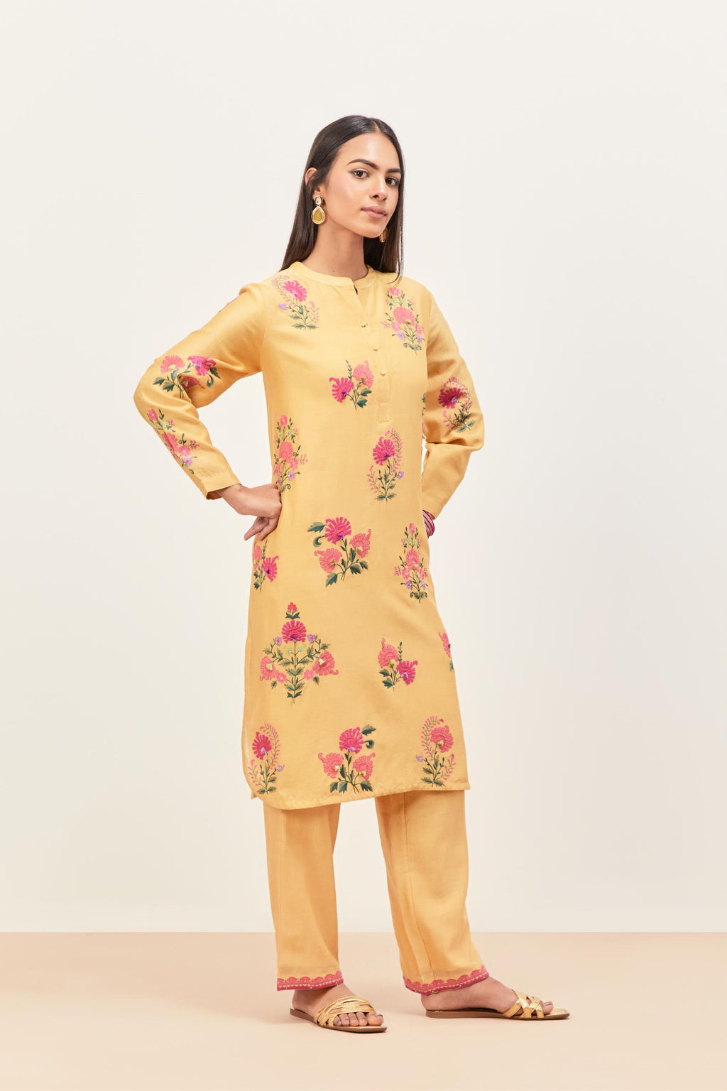 Yellow silk chanderi straight short easy fit kurta set with all-over assorted flower applique, highlighted with aari threadwork & sequins.