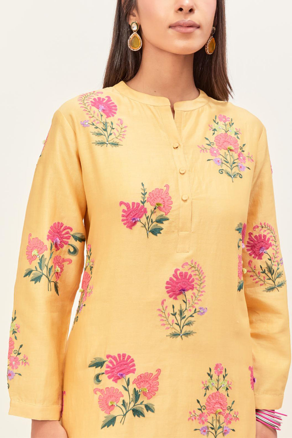 Yellow silk chanderi straight short easy fit kurta set with all-over assorted flower applique, highlighted with aari threadwork & sequins.