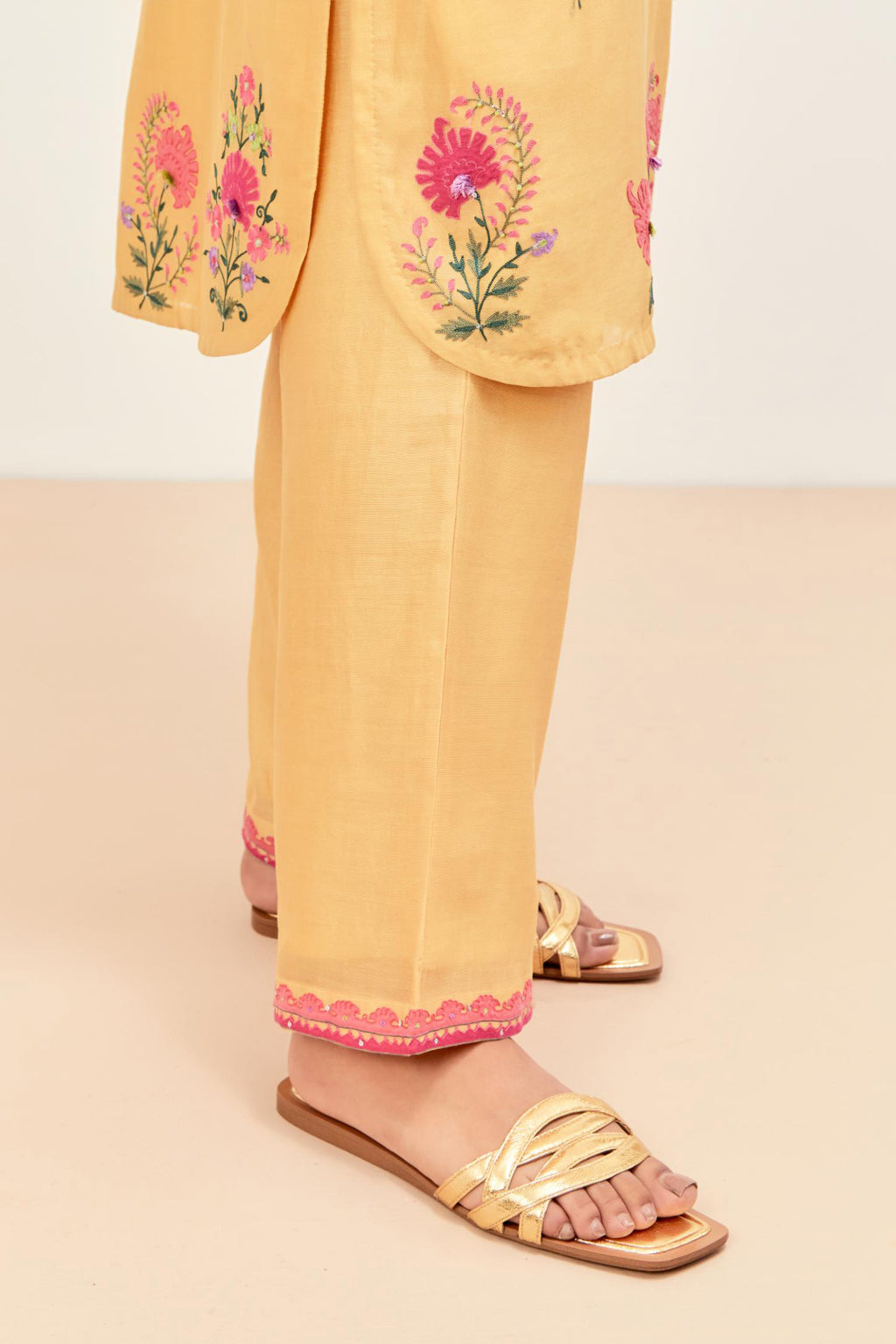 Yellow silk chanderi straight short easy fit kurta set with all-over assorted flower applique, highlighted with aari threadwork & sequins.
