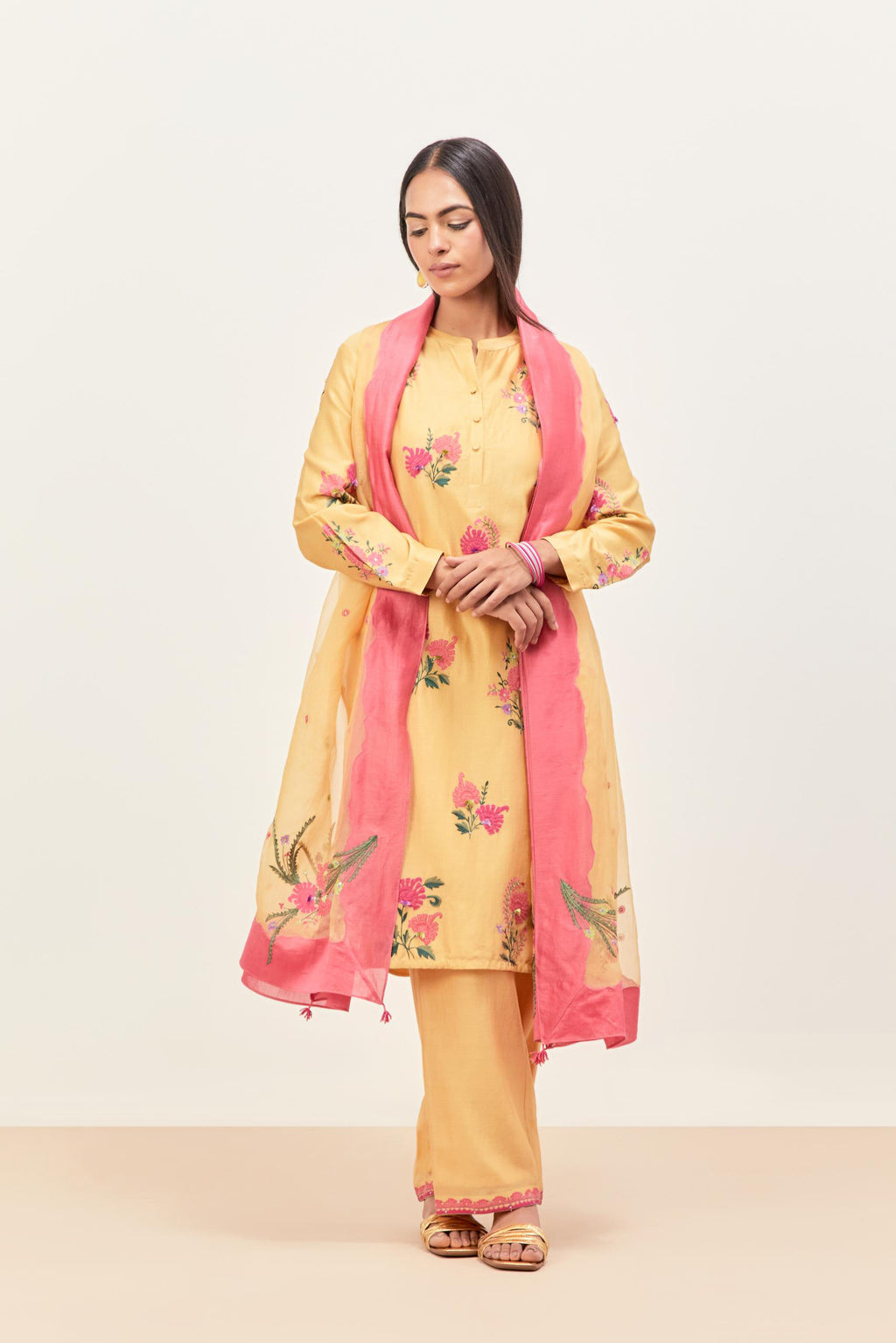 Yellow silk chanderi straight short easy fit kurta set with all-over assorted flower applique, highlighted with aari threadwork & sequins.