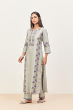 Bluish Grey silk chanderi straight kurta set, decorated with appliqué borders along the side panels, neck and sleeves.