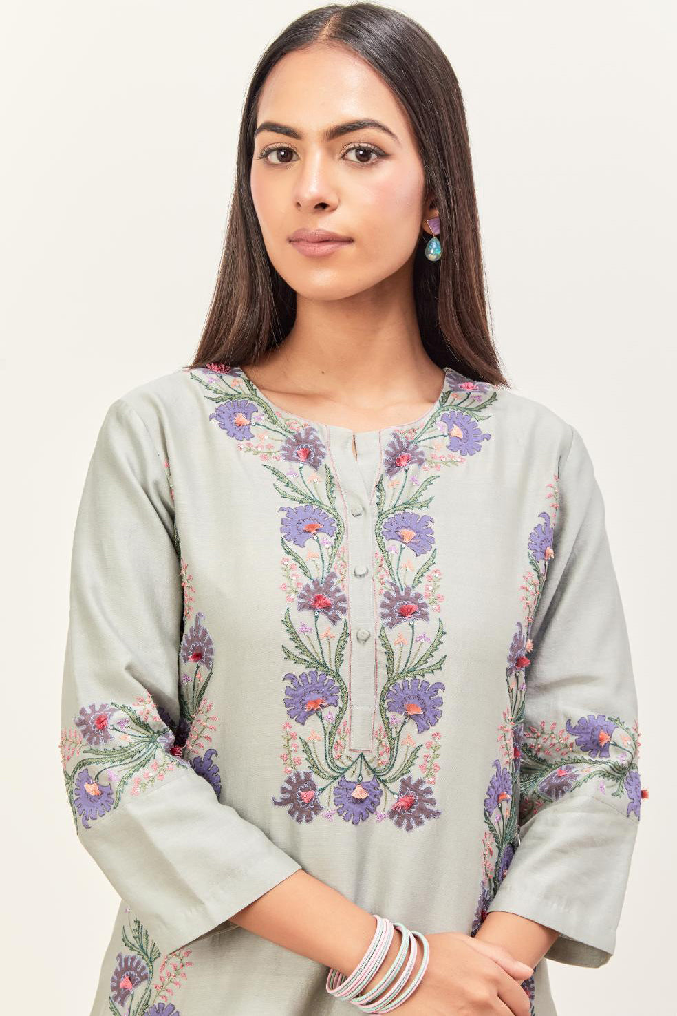 Bluish Grey silk chanderi straight kurta set, decorated with appliqué borders along the side panels, neck and sleeves.