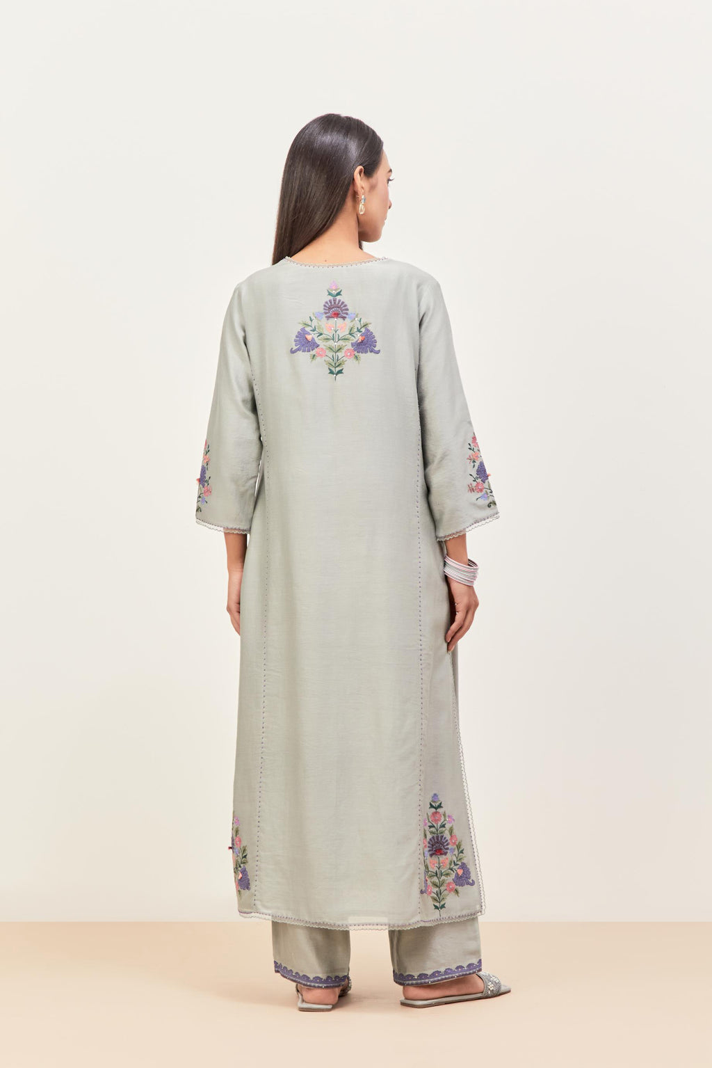 Bluish Grey silk chanderi kurta set with pin tucks in the front & back and floral applique boota at sides, highlighted with aari threadwork & sequins.