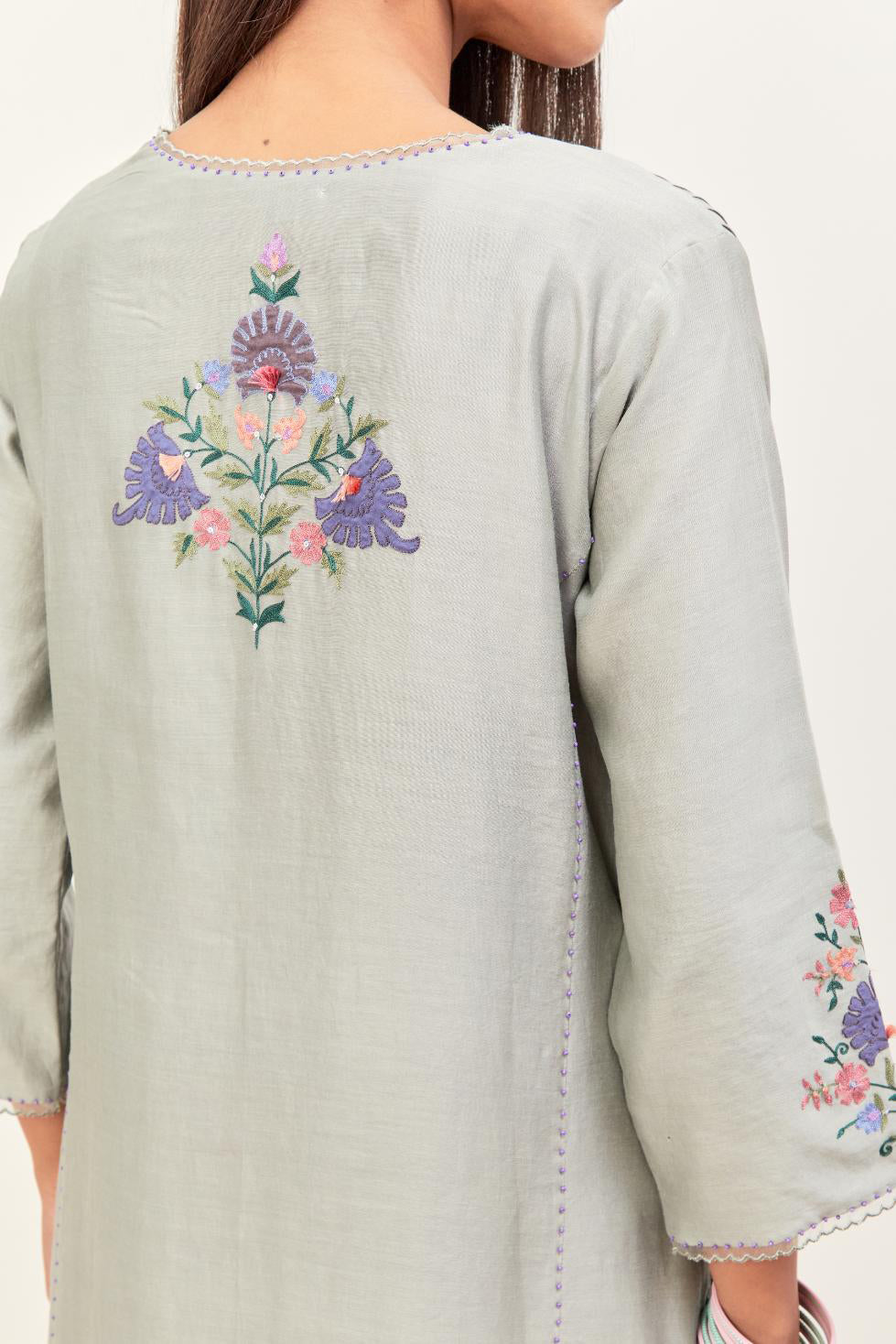 Bluish Grey silk chanderi kurta set with pin tucks in the front & back and floral applique boota at sides, highlighted with aari threadwork & sequins.