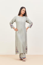 Bluish Grey silk chanderi kurta set with pin tucks in the front & back and floral applique boota at sides, highlighted with aari threadwork & sequins.