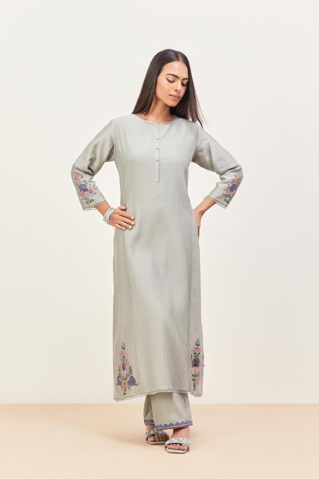 Bluish Grey silk chanderi kurta set with pin tucks in the front & back and floral applique boota at sides, highlighted with aari threadwork & sequins.