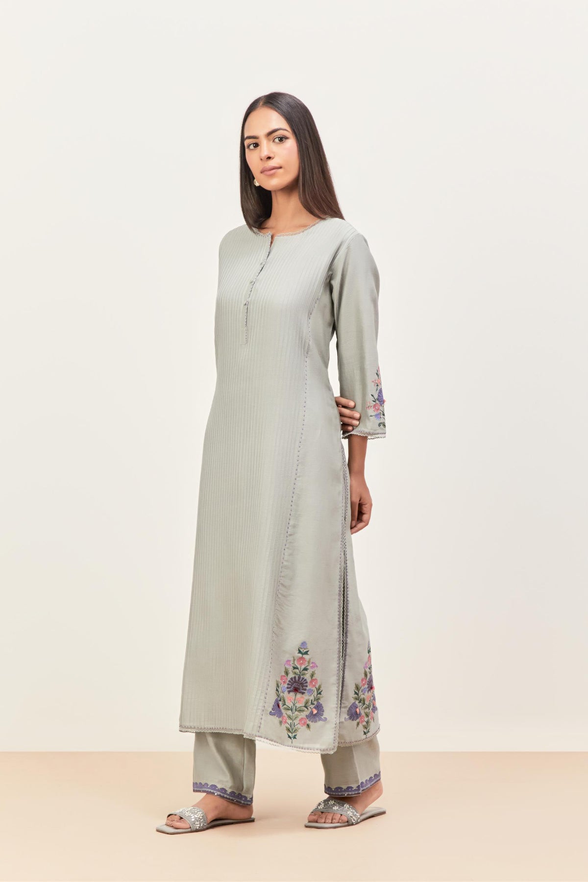 Bluish Grey silk chanderi kurta set with pin tucks in the front & back and floral applique boota at sides, highlighted with aari threadwork & sequins.
