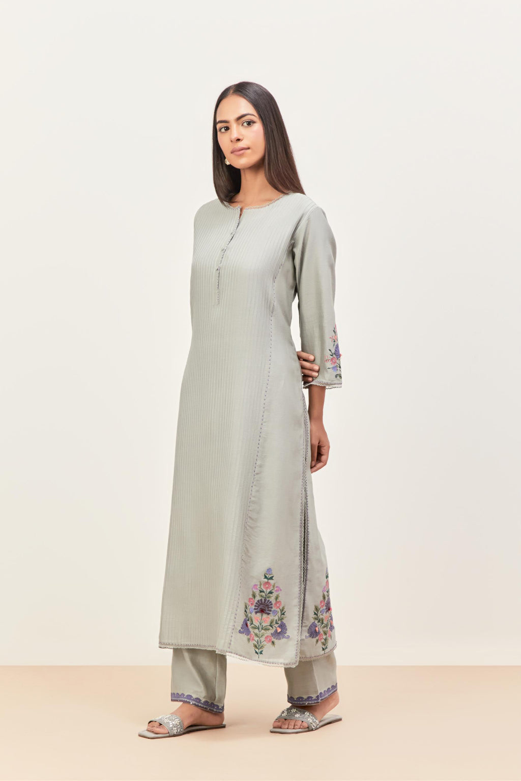 Bluish Grey silk chanderi kurta set with pin tucks in the front & back and floral applique boota at sides, highlighted with aari threadwork & sequins.