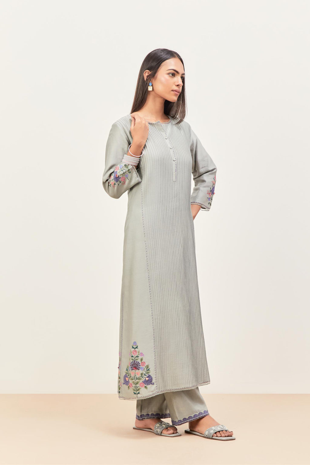 Bluish Grey silk chanderi kurta set with pin tucks in the front & back and floral applique boota at sides, highlighted with aari threadwork & sequins.