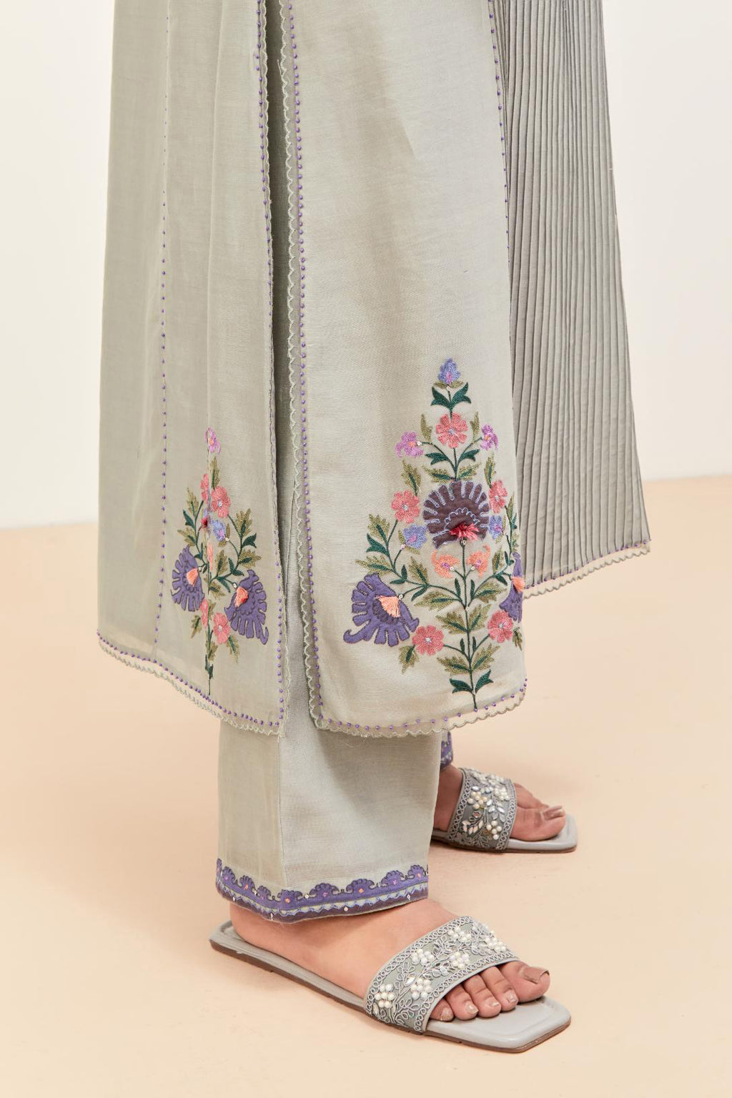 Bluish Grey silk chanderi kurta set with pin tucks in the front & back and floral applique boota at sides, highlighted with aari threadwork & sequins.