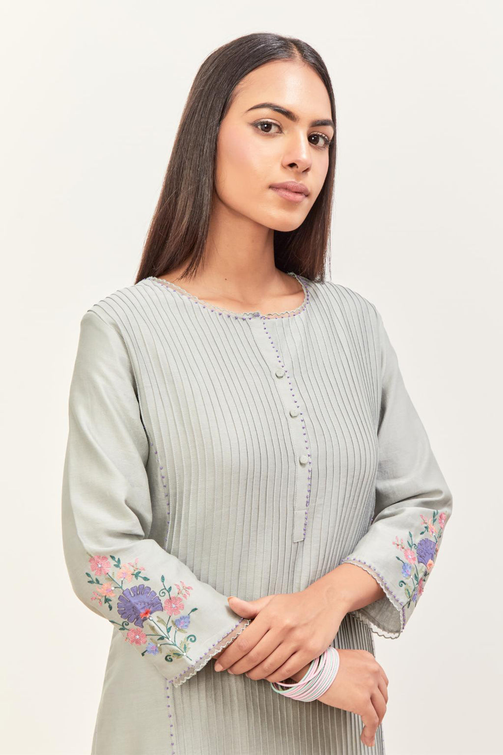 Bluish Grey silk chanderi kurta set with pin tucks in the front & back and floral applique boota at sides, highlighted with aari threadwork & sequins.