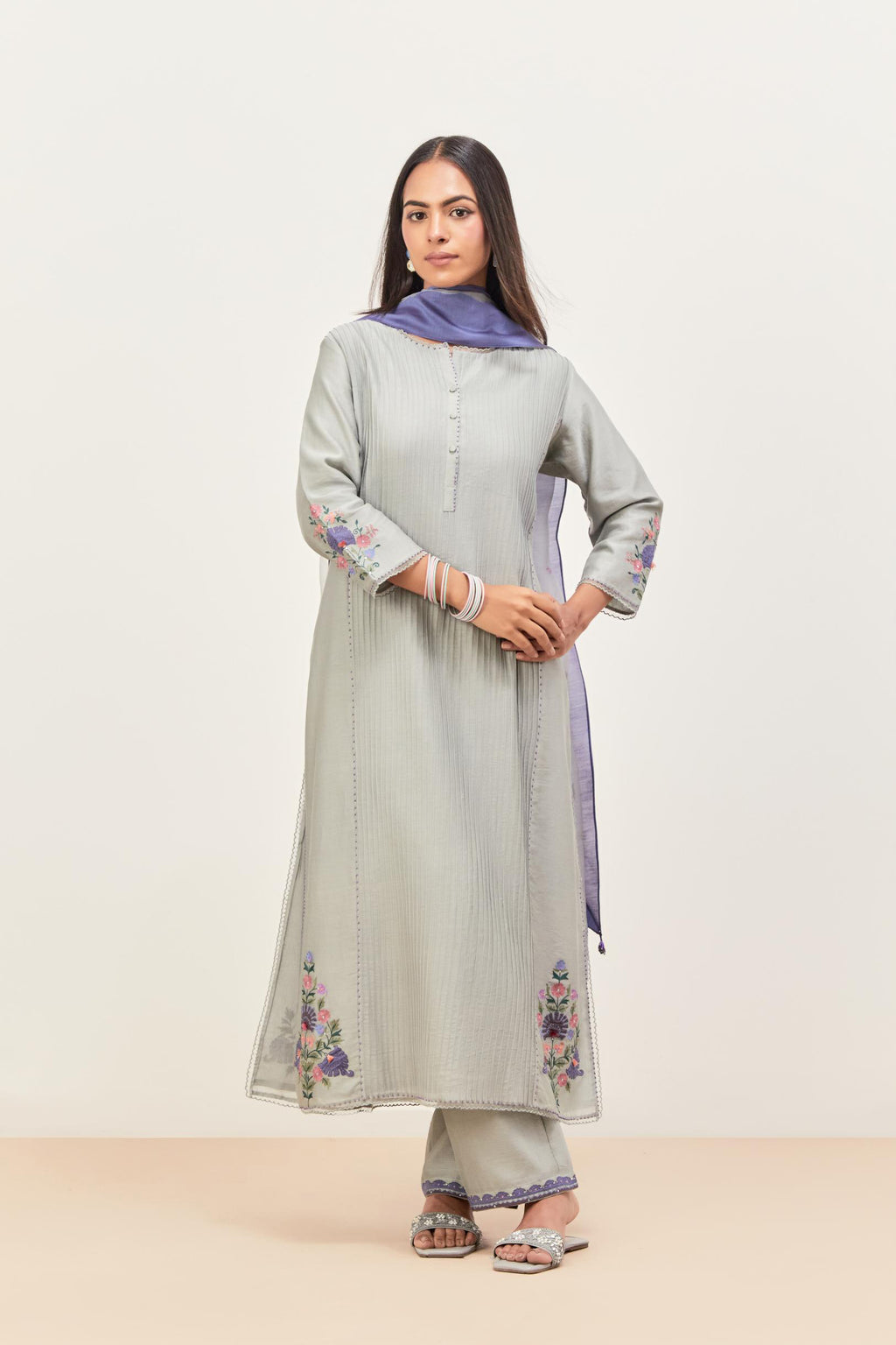 Bluish Grey silk chanderi kurta set with pin tucks in the front & back and floral applique boota at sides, highlighted with aari threadwork & sequins.