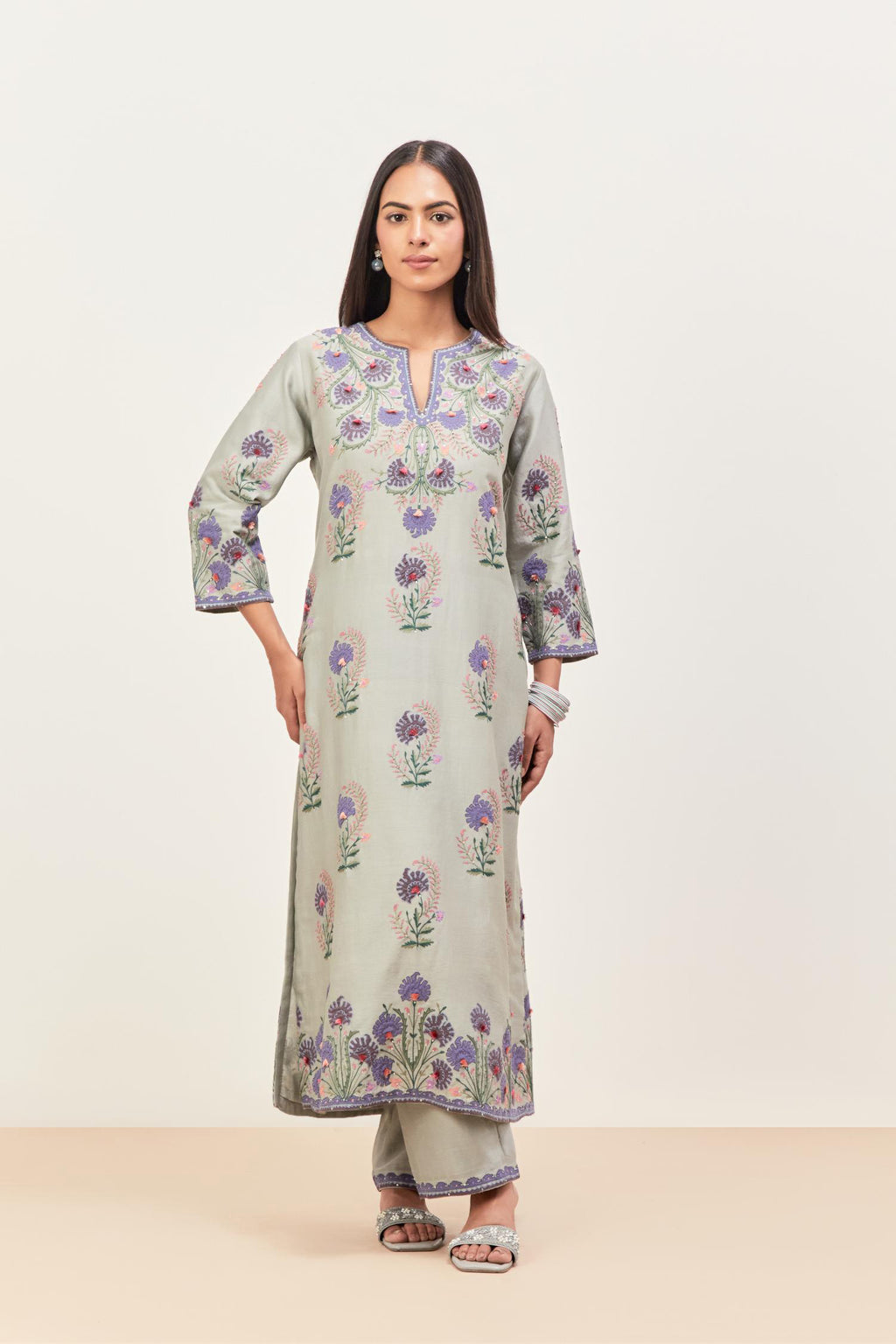 Bluish Grey silk chanderi straight kurta set, decorated with appliqued jaal neckline and hem. The field has symmetrically placed bootas.