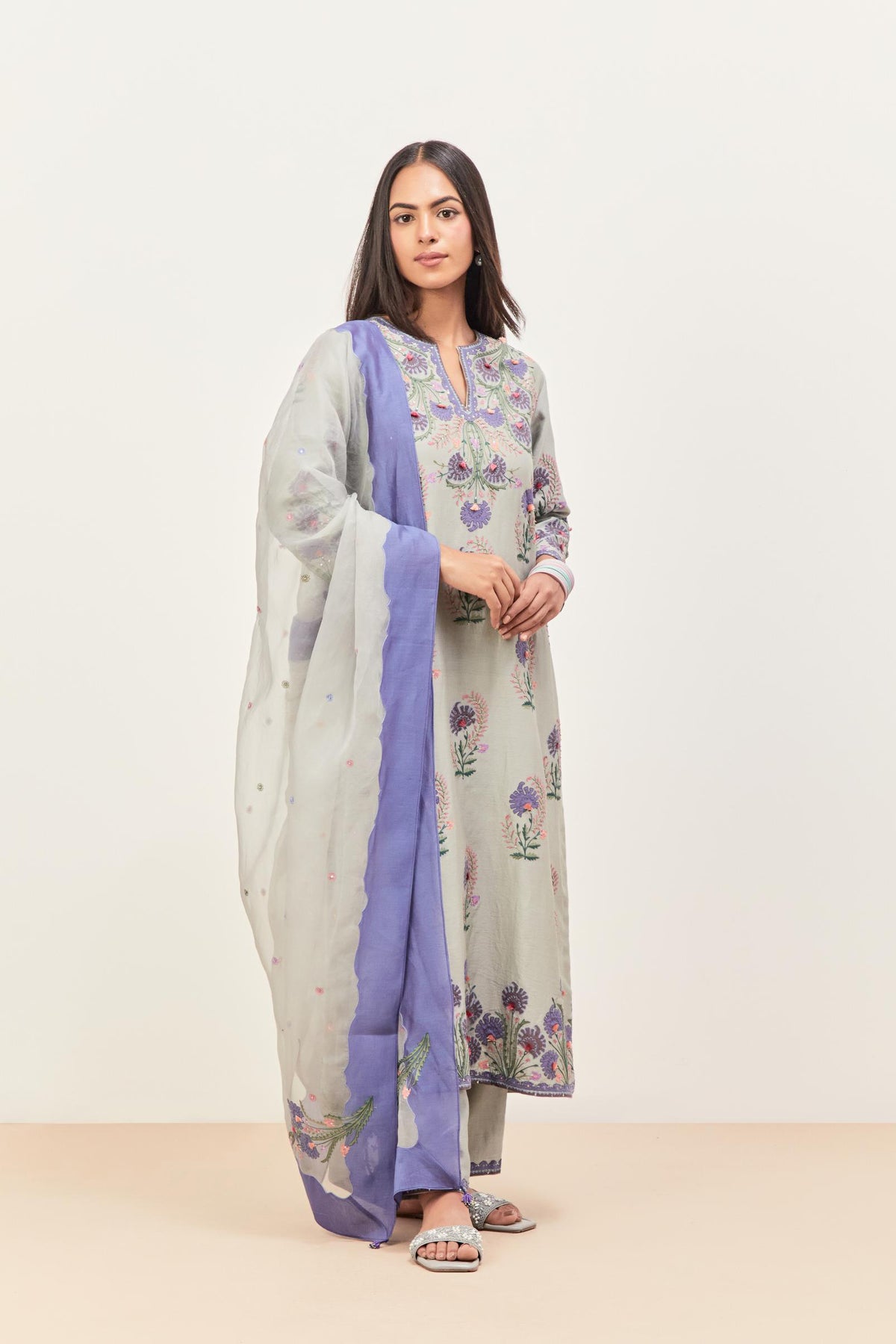 Bluish Grey silk chanderi straight kurta set, decorated with appliqued jaal neckline and hem. The field has symmetrically placed bootas.