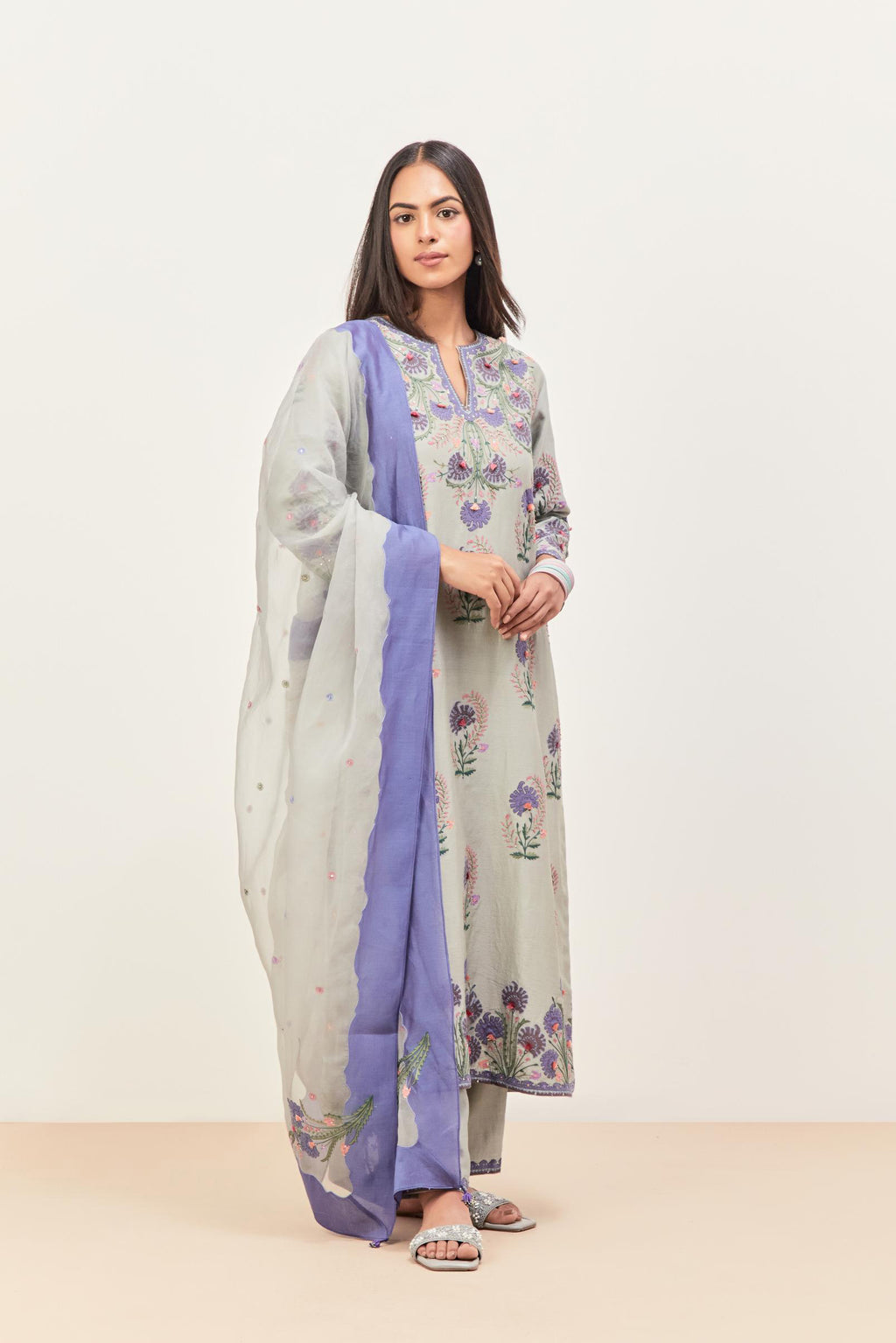 Bluish Grey silk chanderi straight kurta set, decorated with appliqued jaal neckline and hem. The field has symmetrically placed bootas.