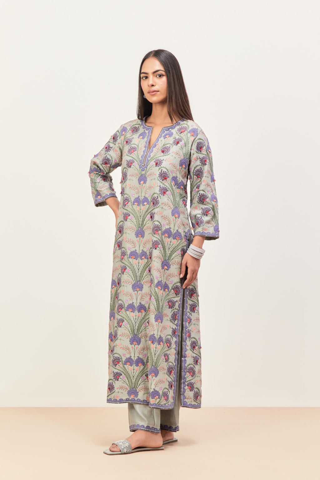 Bluish Grey straight kurta set, fully embroidered with appliqué flowers, multi-colored aari threadwork and silk tassels.