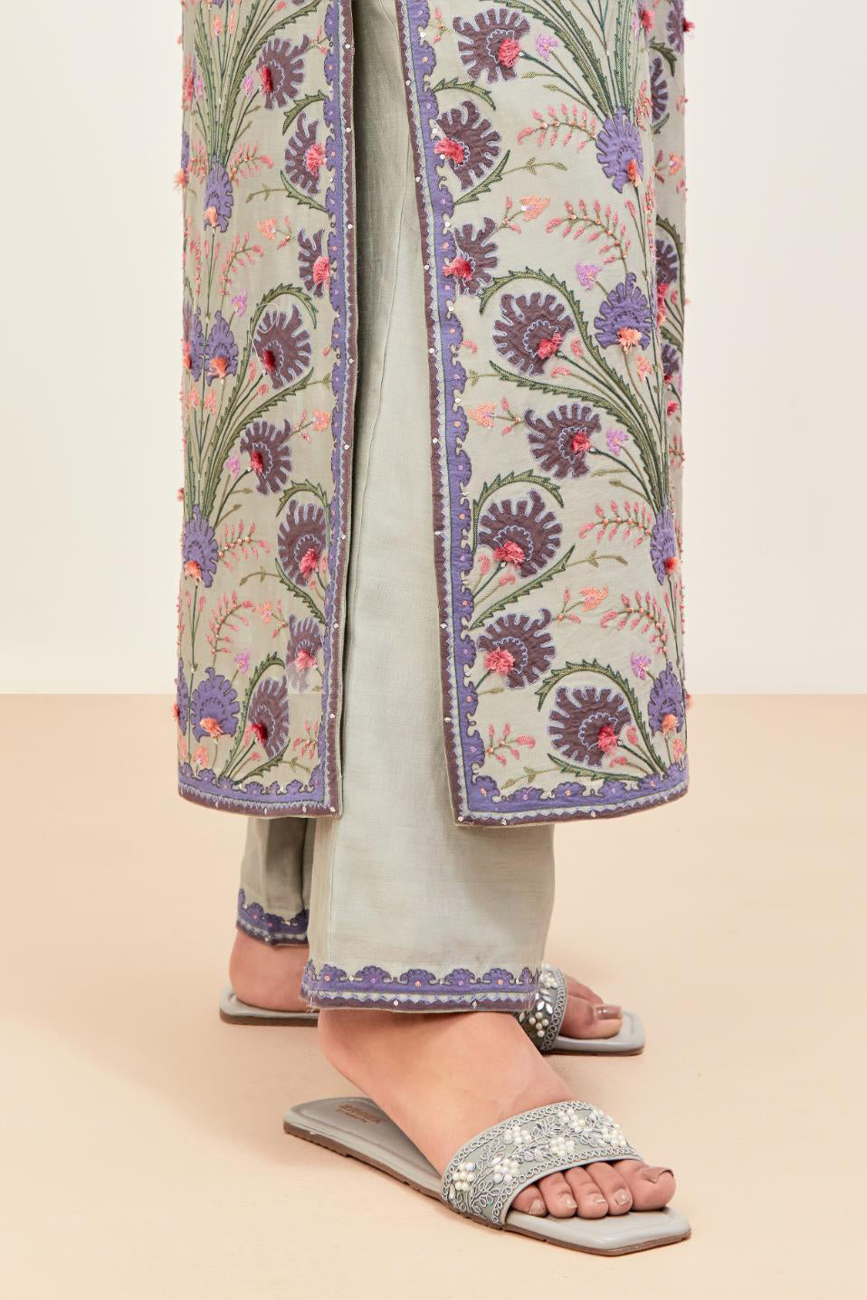 Bluish Grey straight kurta set, fully embroidered with appliqué flowers, multi-colored aari threadwork and silk tassels.
