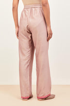 Lilac silk chanderi straight pants detailed with multi colored applique, highlighted with sequins work at bottom hem.