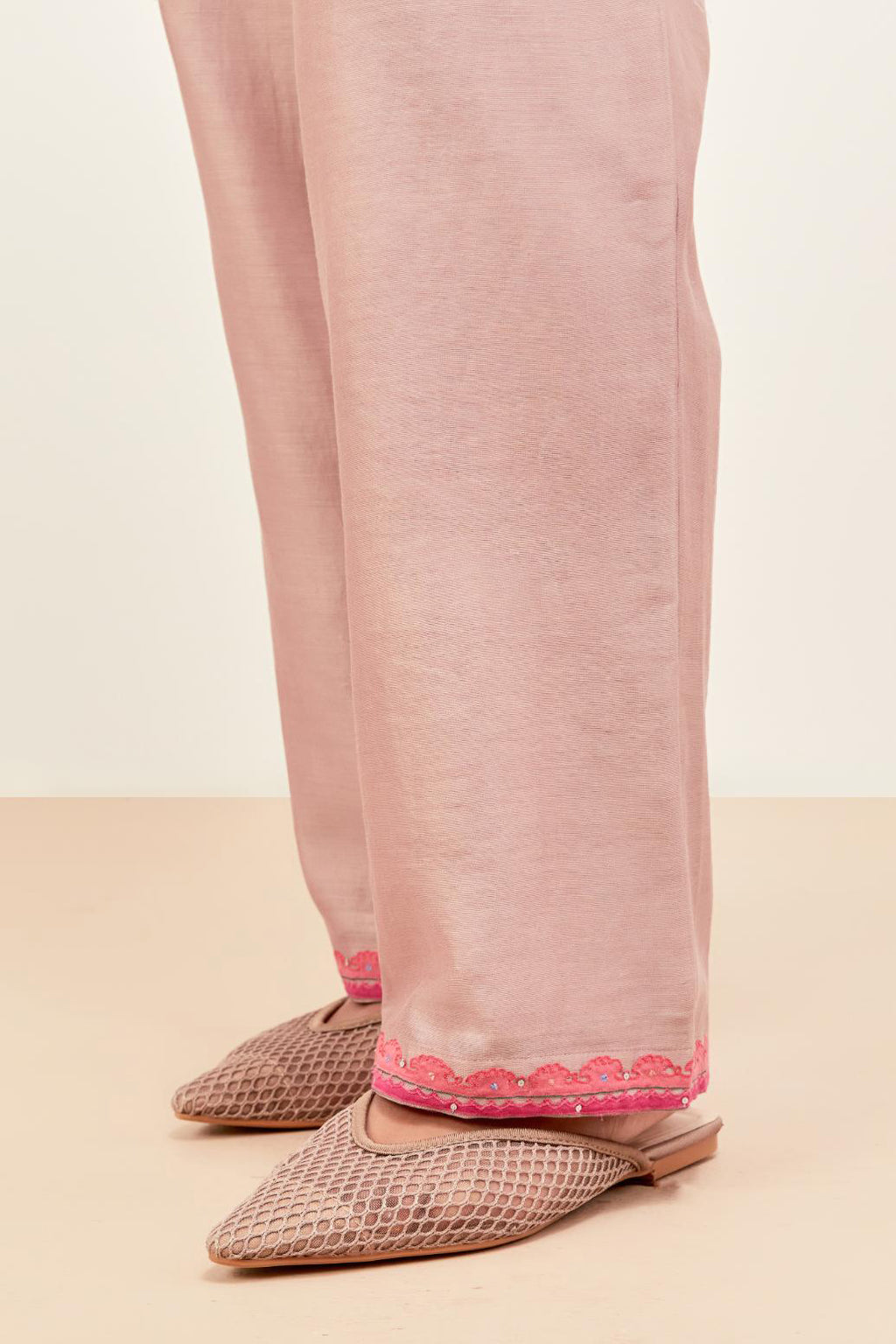 Lilac silk chanderi straight pants detailed with multi colored applique, highlighted with sequins work at bottom hem.