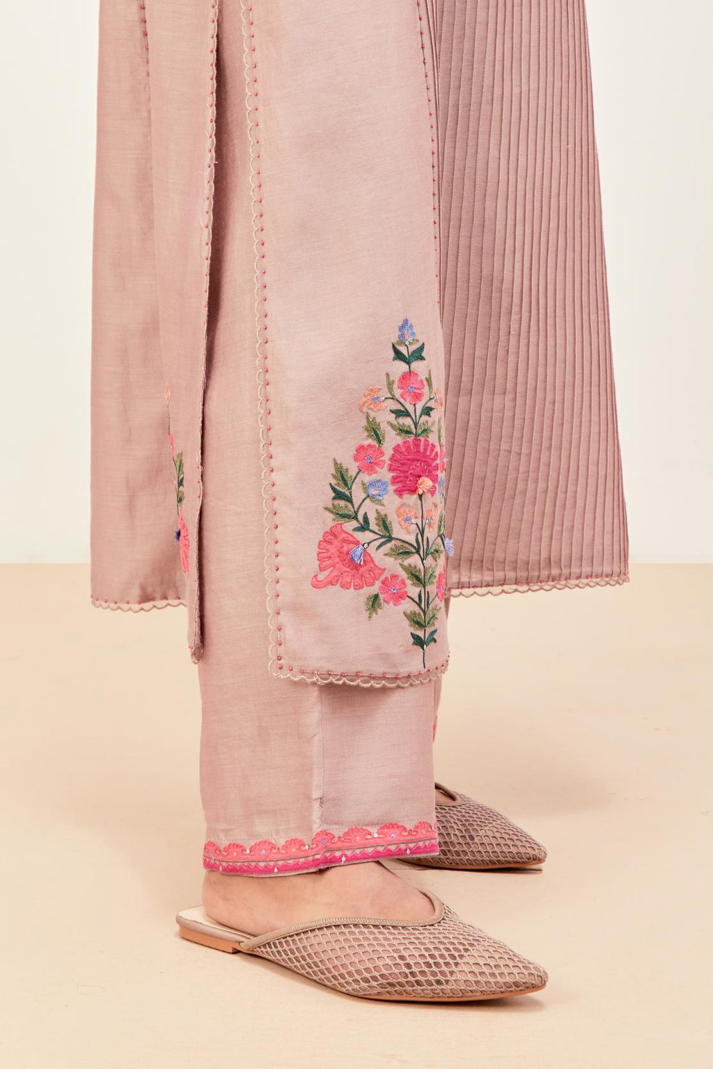 Lilac silk chanderi kurta set with pin tucks in the front & back and floral applique boota at sides, highlighted with aari threadwork & sequins.