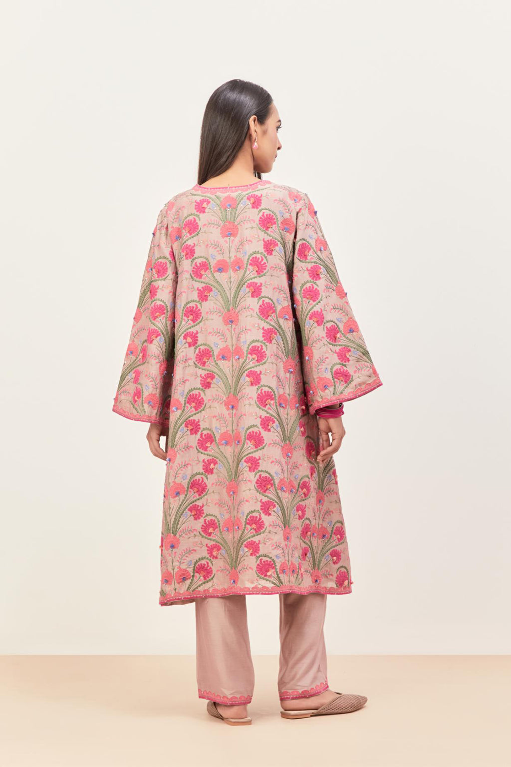Lilac short A-line silk chanderi kurta set, fully embroidered with appliqué flowers, highlighted with aari thread work and silk tassels.