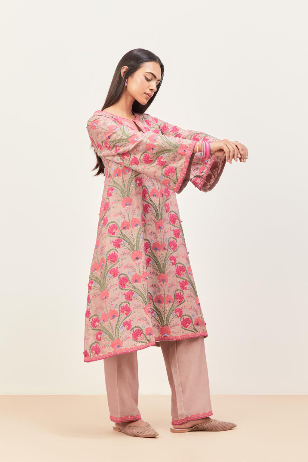 Lilac short A-line silk chanderi kurta set, fully embroidered with appliqué flowers, highlighted with aari thread work and silk tassels.