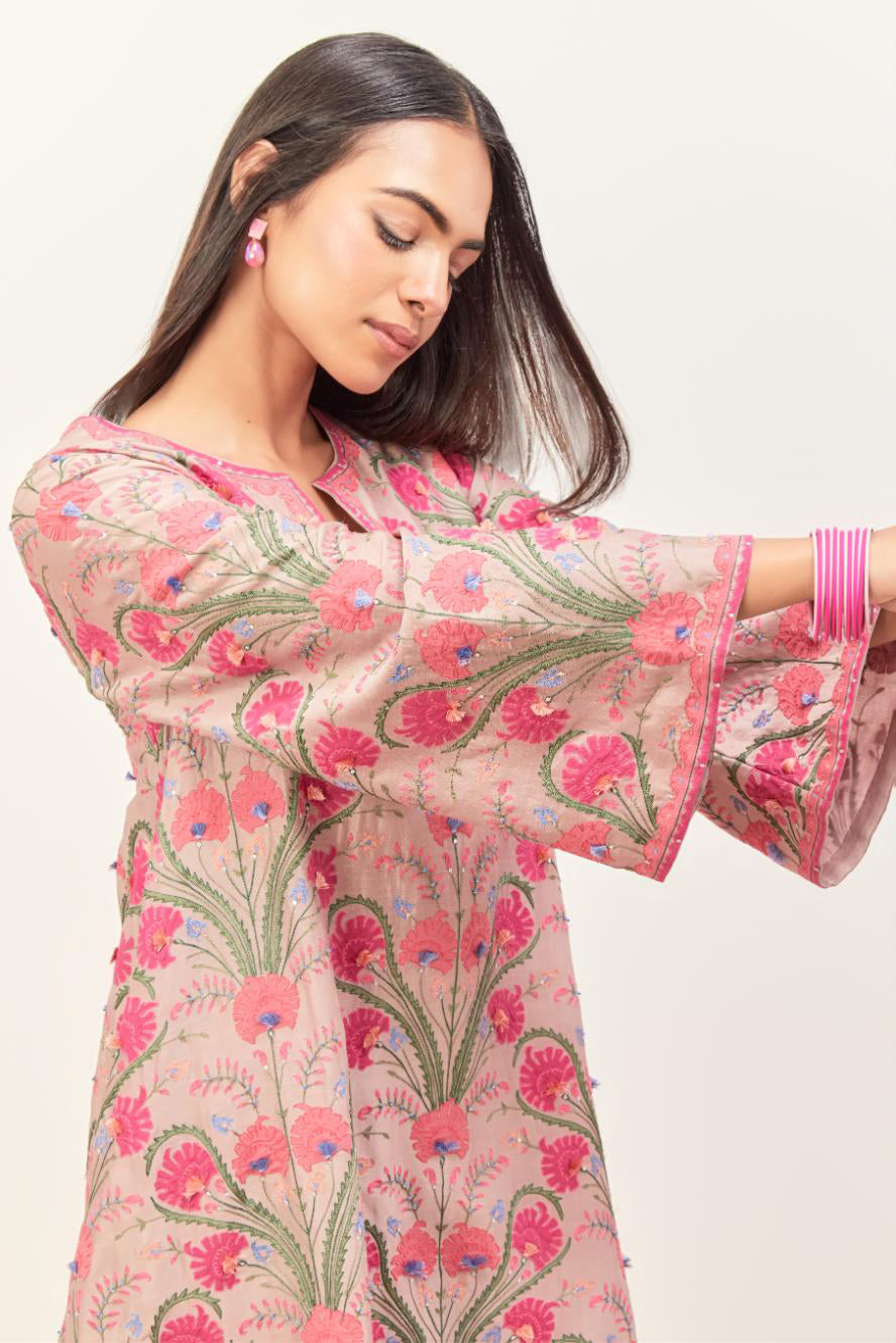 Lilac short A-line silk chanderi kurta set, fully embroidered with appliqué flowers, highlighted with aari thread work and silk tassels.
