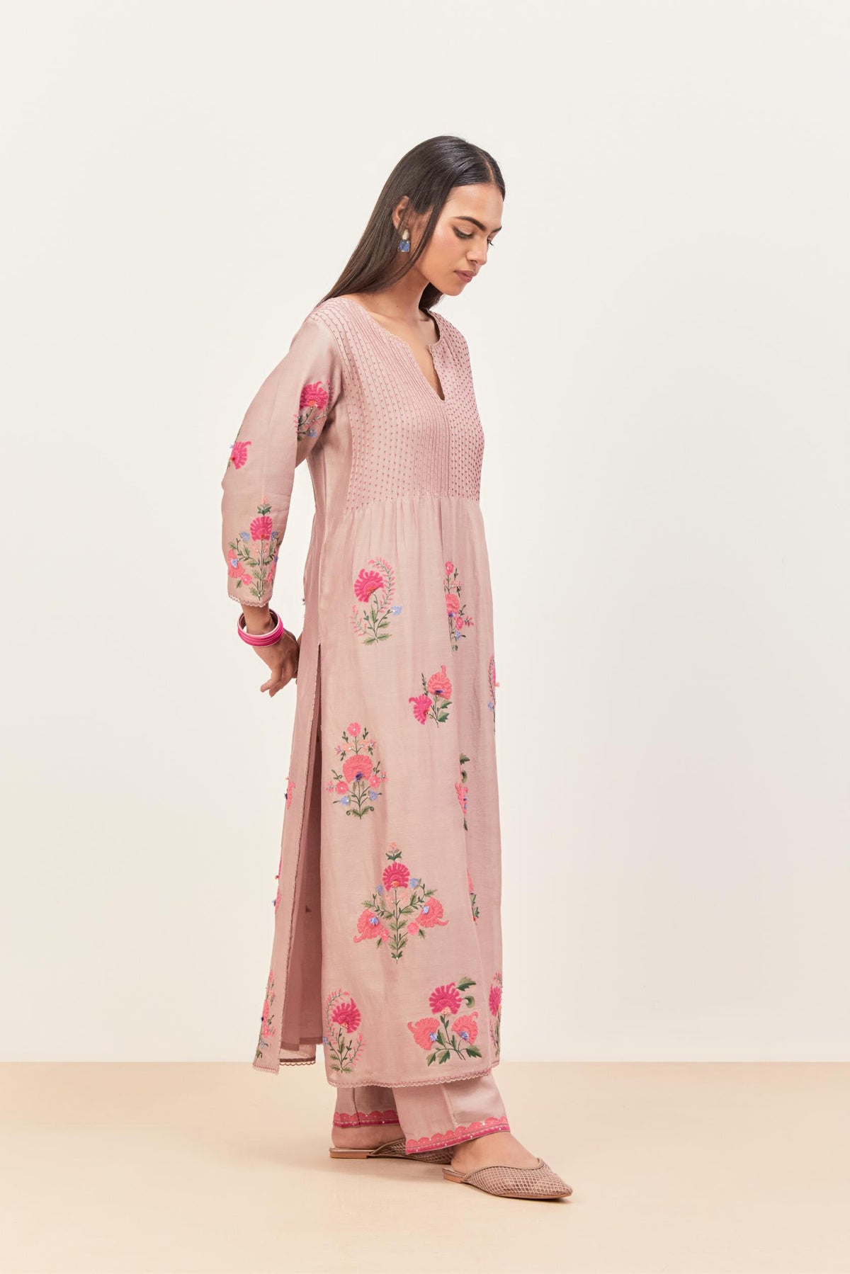 Lilac silk chanderi kurta set with pin tucks at yoke and all-over applique, highlighted with aari threadwork & sequins.