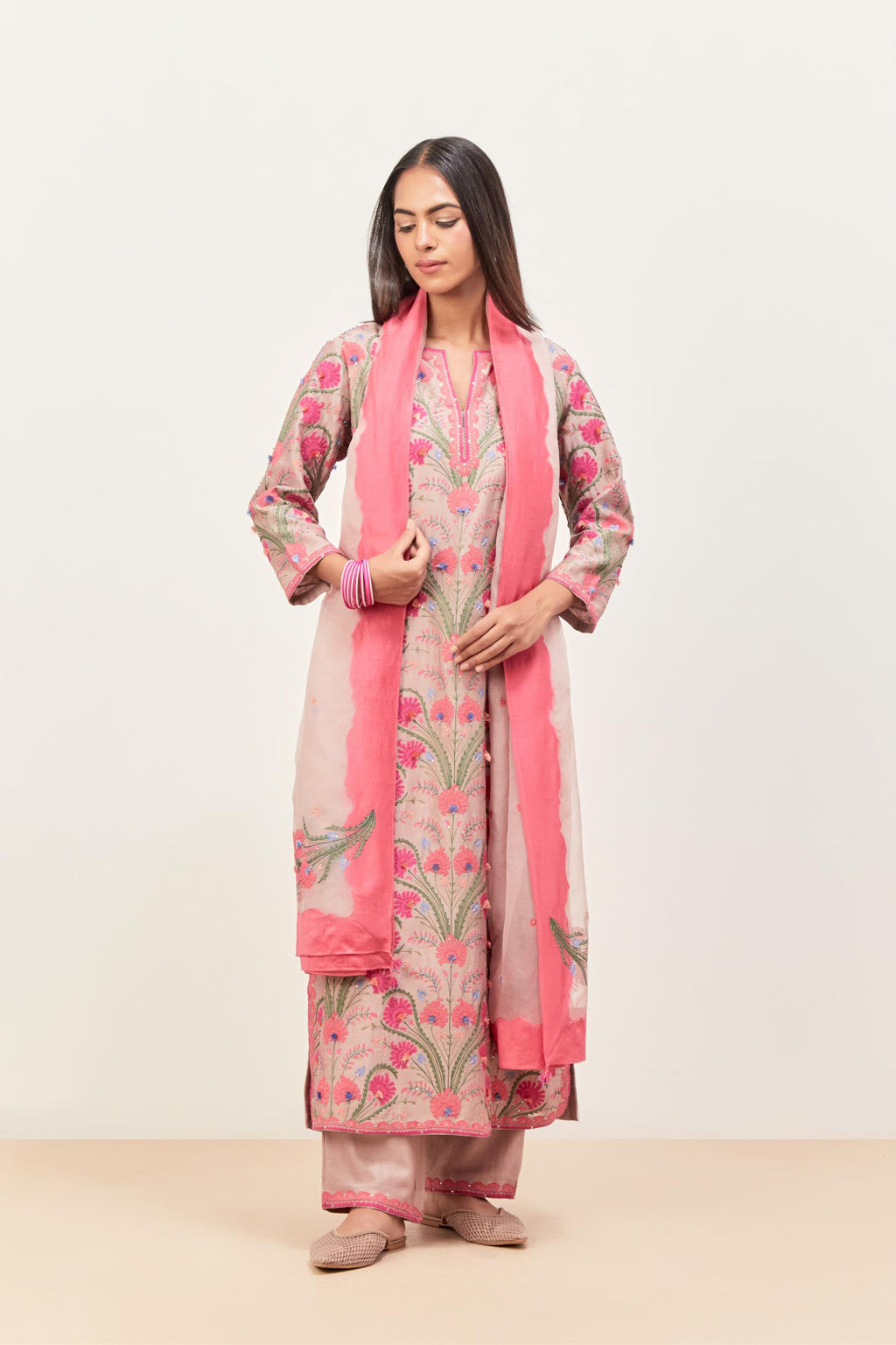 Lilac straight kurta set, fully embroidered with appliqué flowers, multi-colored aari threadwork and silk tassels.