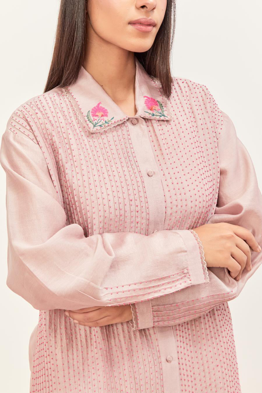 Lilac silk chanderi shirt with all-over pin tucks, highlighted with contrast beads in the front, paired with Lilac silk chanderi straight pants detailed with multi colored applique, highlighted with sequins work at bottom hem.